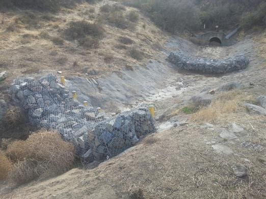 A road with rocks and grass on it