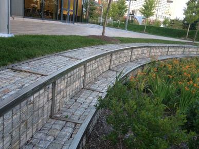 Curved Wall by GABION SUPPLY in a garden