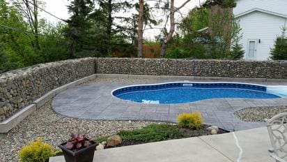 A pool that is in the middle of some grass.