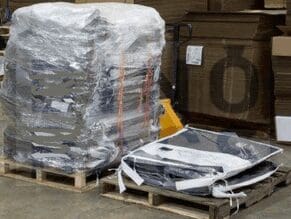 A pallet of computer equipment wrapped in plastic.