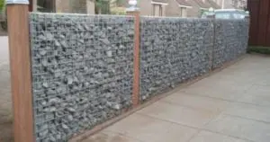 closeup view of a Gabion Fence with wooden poles