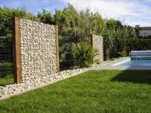 Gabion Fence in a garden with a pool