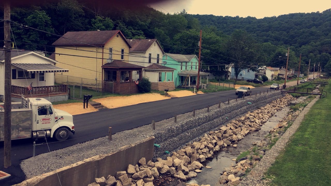A road with some houses on it and trees
