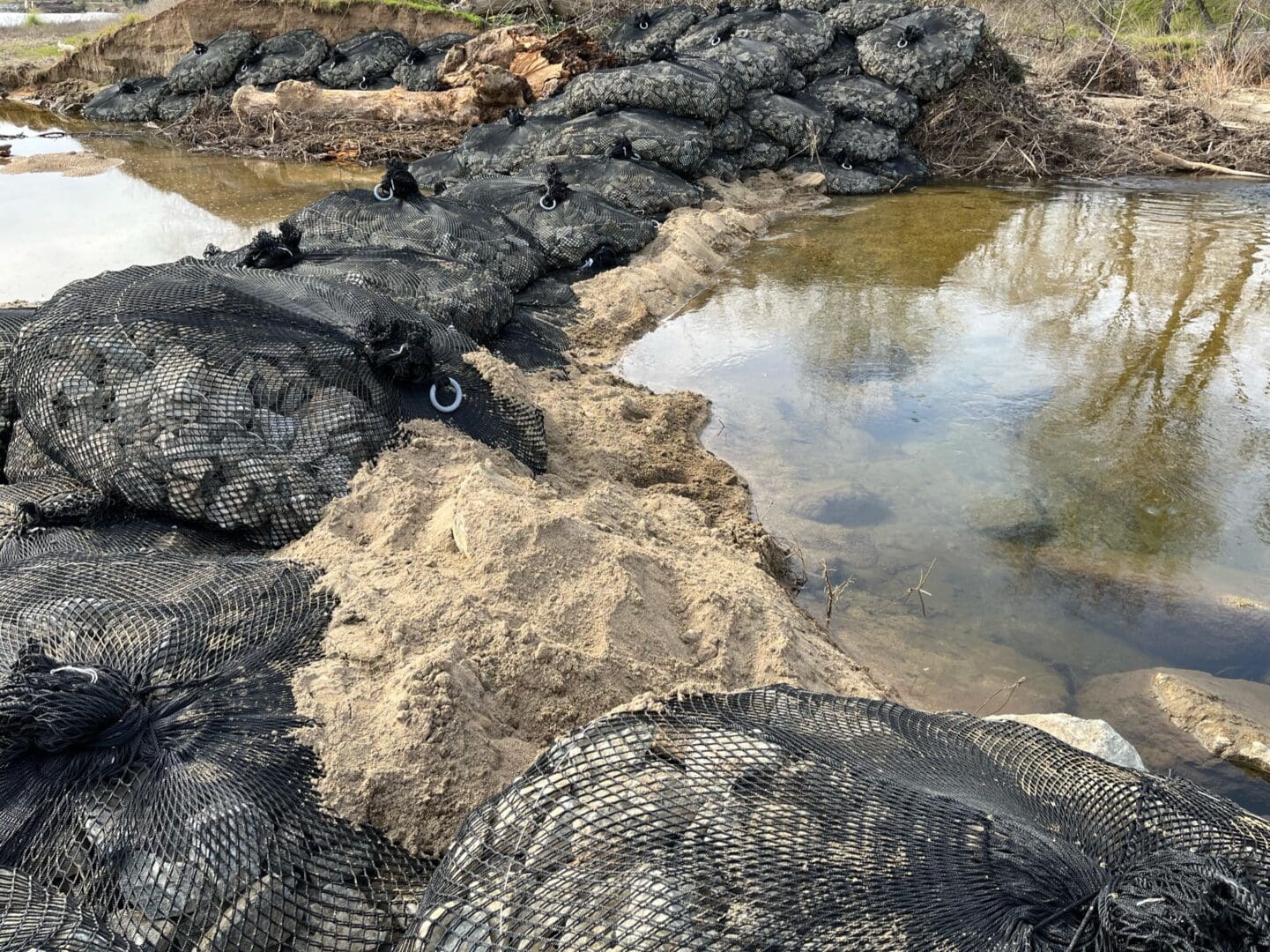 A group of rocks that are next to water.